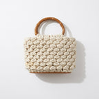 Woven handbag with wooden handle on a white background - tryon